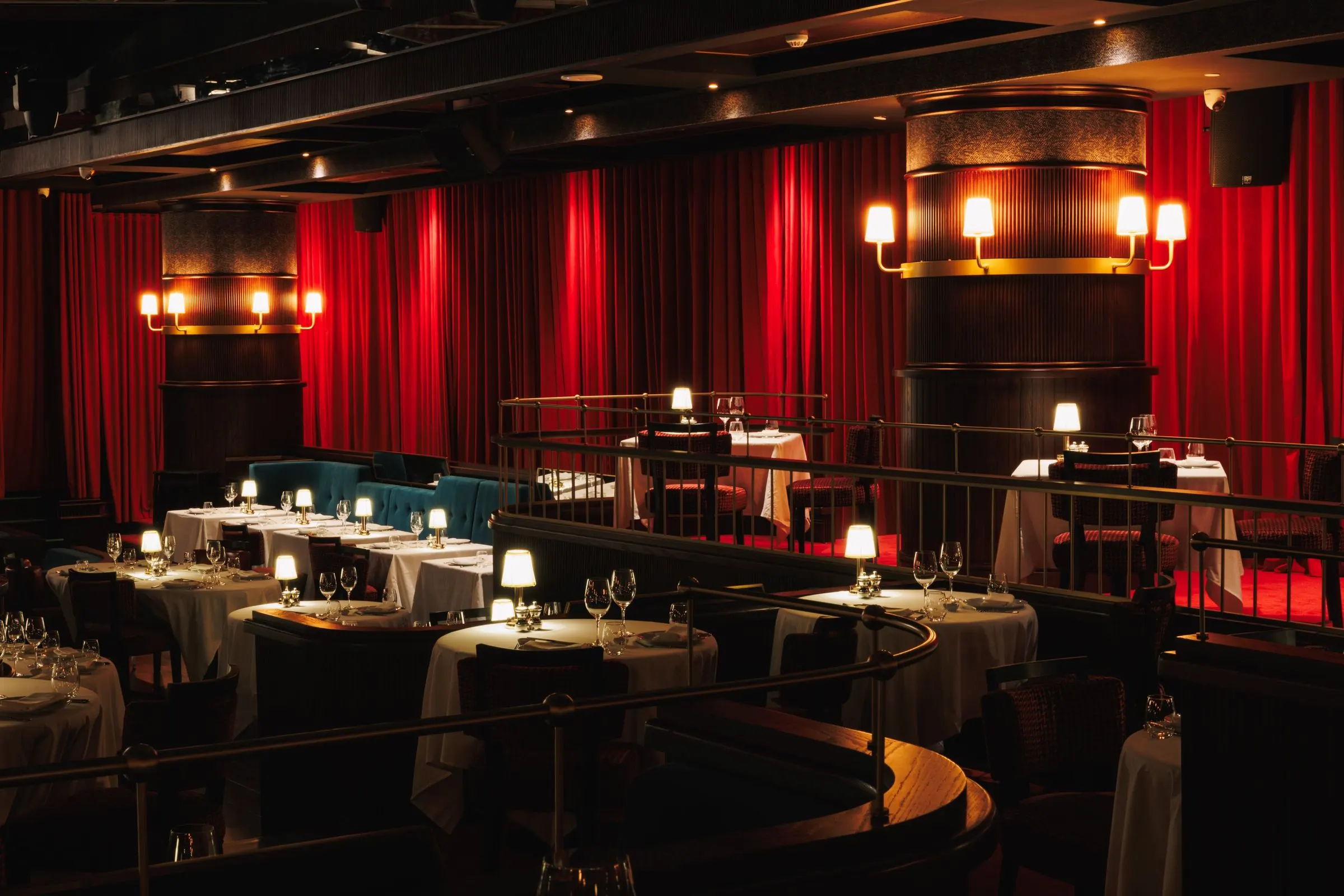 The red-curtained Billionaire dining room with set tables